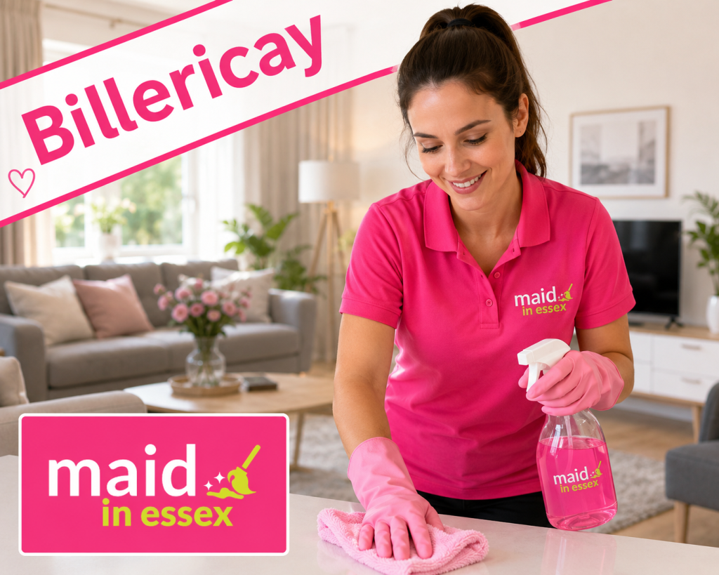 Cleaner in pink Maid in Essex uniform wiping a kitchen counter in a bright modern home, with Billericay text angled across the top and the Maid in Essex logo displayed.